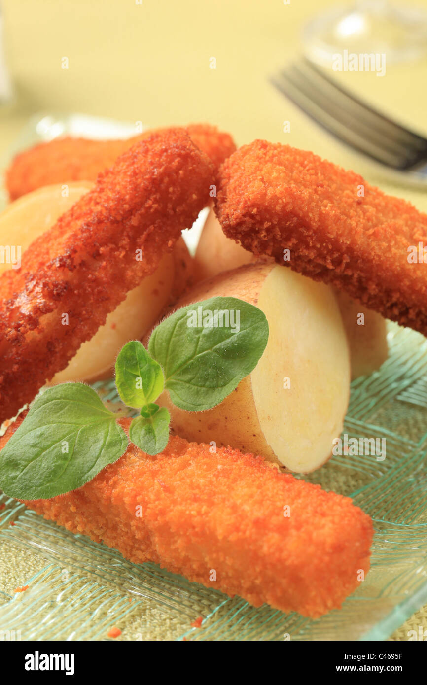 Fried fish fingers and new potatoes detail Stock Photo Alamy