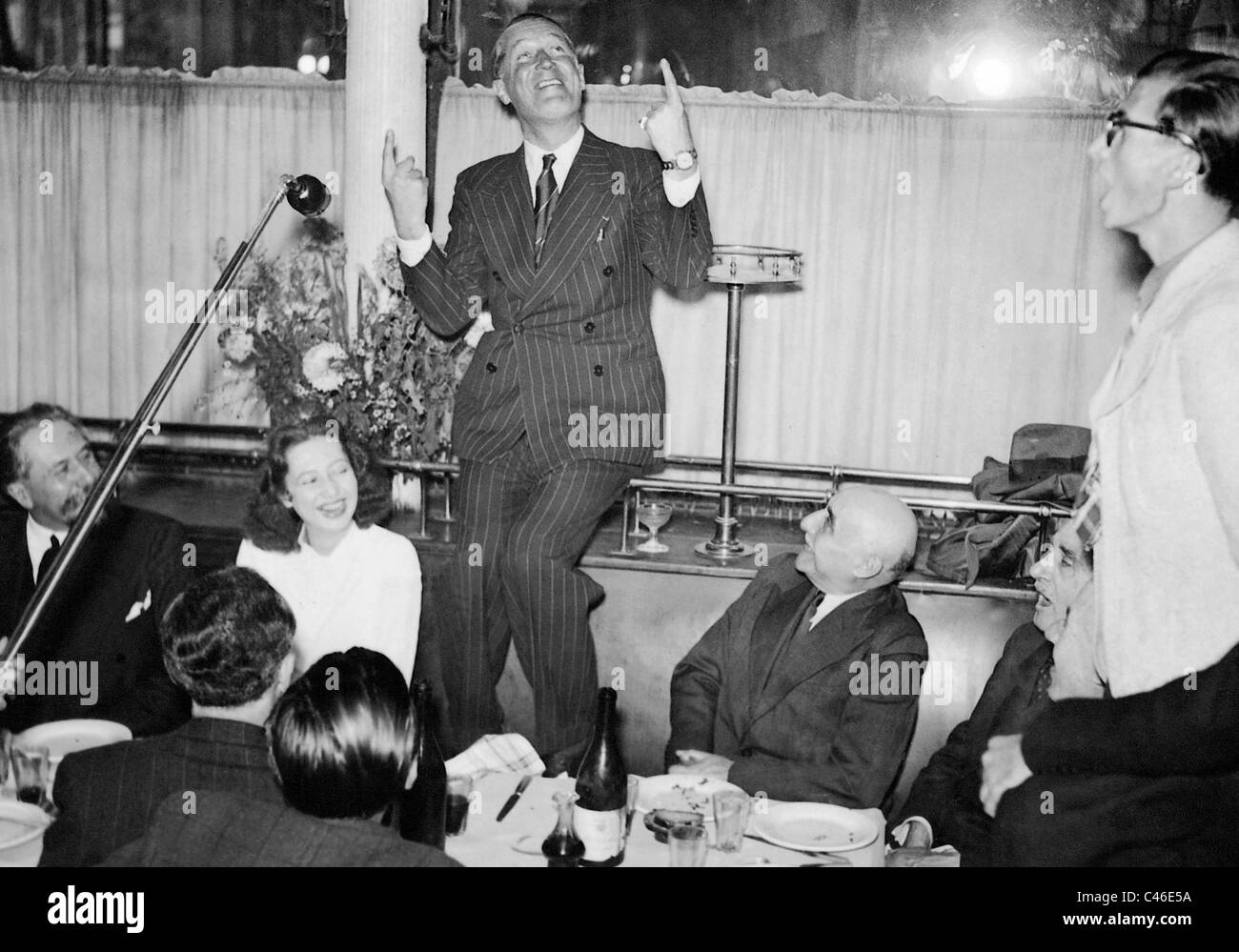 Maurice Chevalier in a restaurant, 1941 Stock Photo