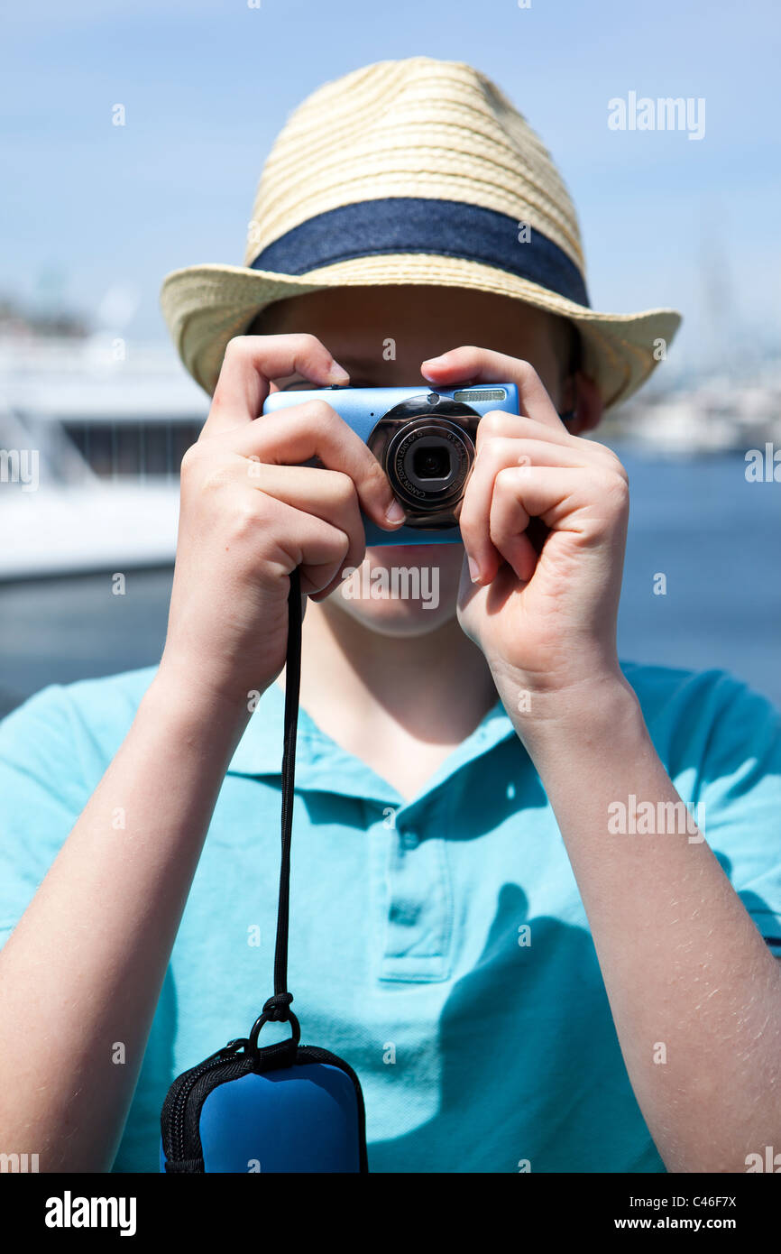 A boy with a hat and a camera in downtown Victoria, BC, Canada Stock ...