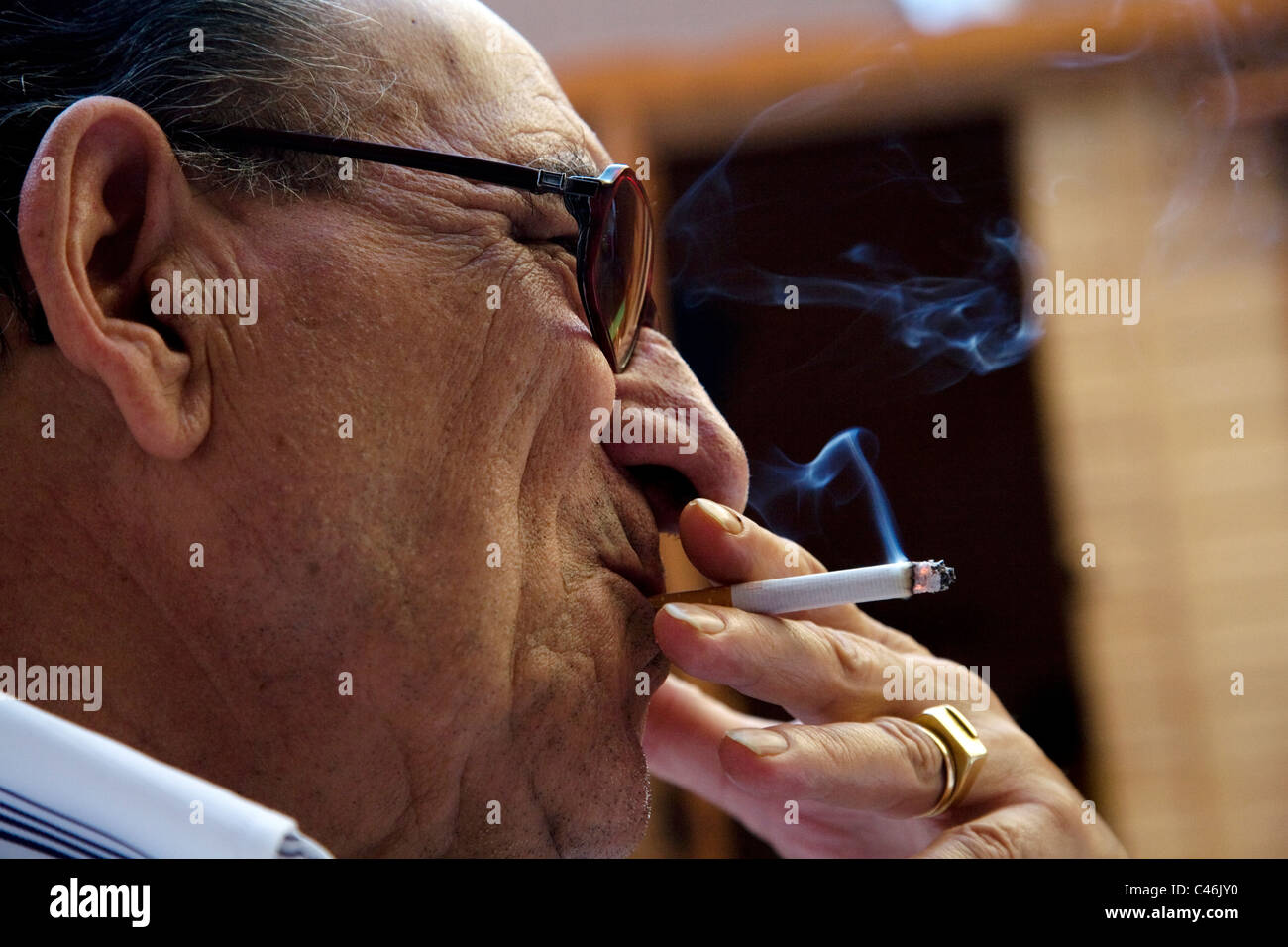 Old Spanish man smoking a cigarette Stock Photo Alamy
