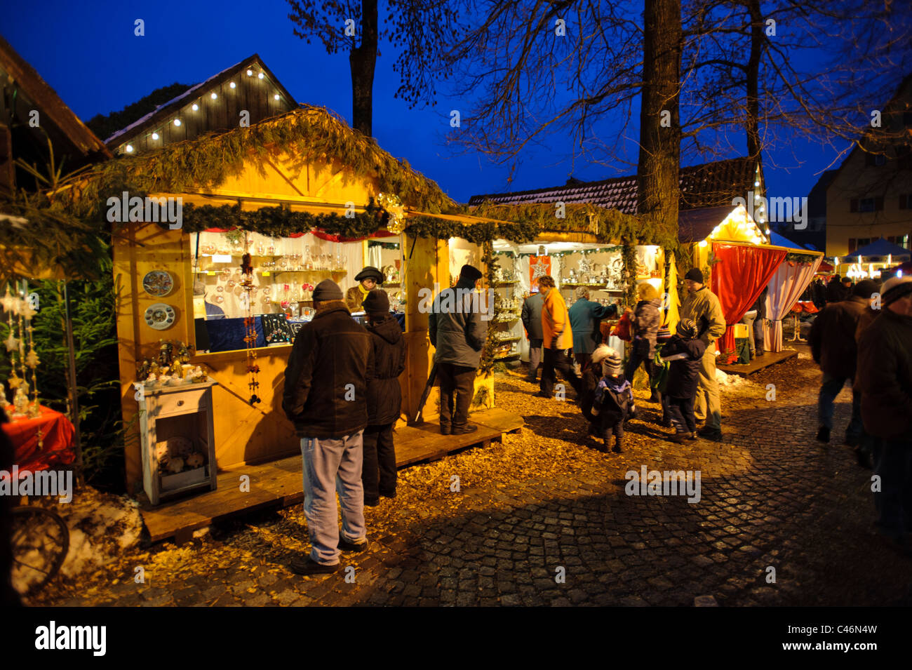 Christmas market at night in city Dinkelsbuehl in Germany, Bavaria, with illuminated shops Stock Photo