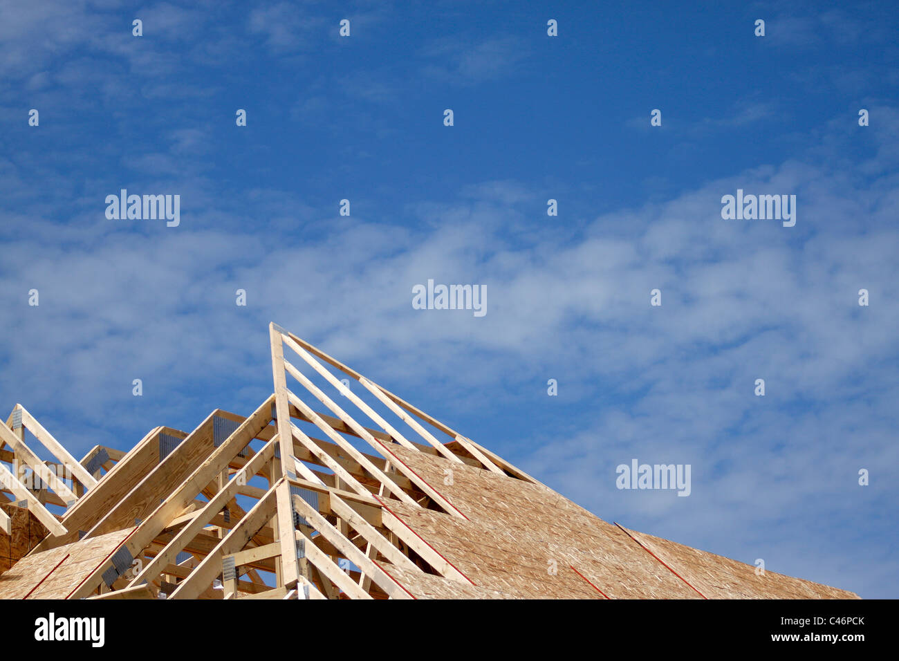 Truss rafters and sheathing on new home construction Stock Photo