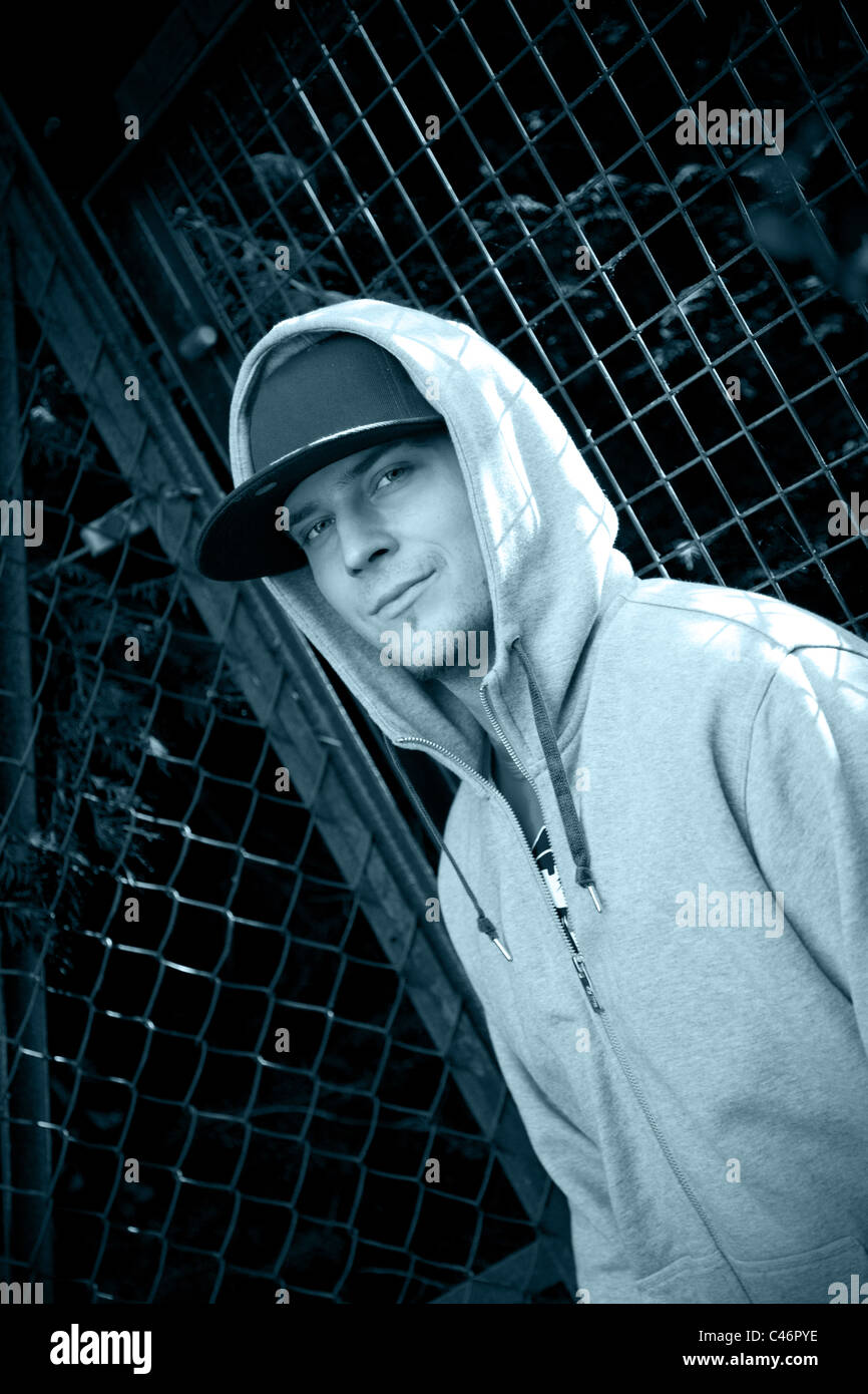 Man wearing a cap and hoodie Stock Photo