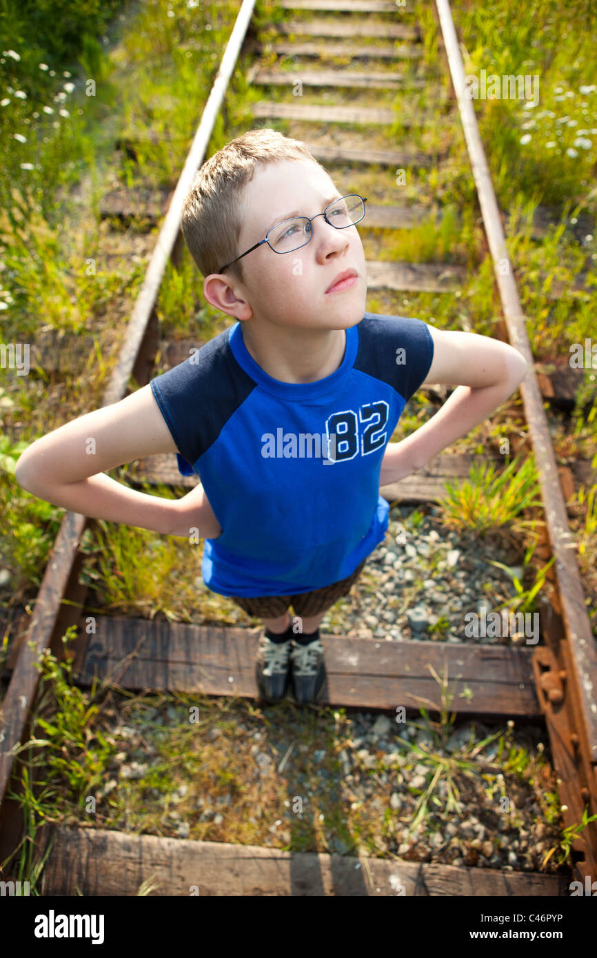 A boy posing on train tracks Stock Photo Alamy