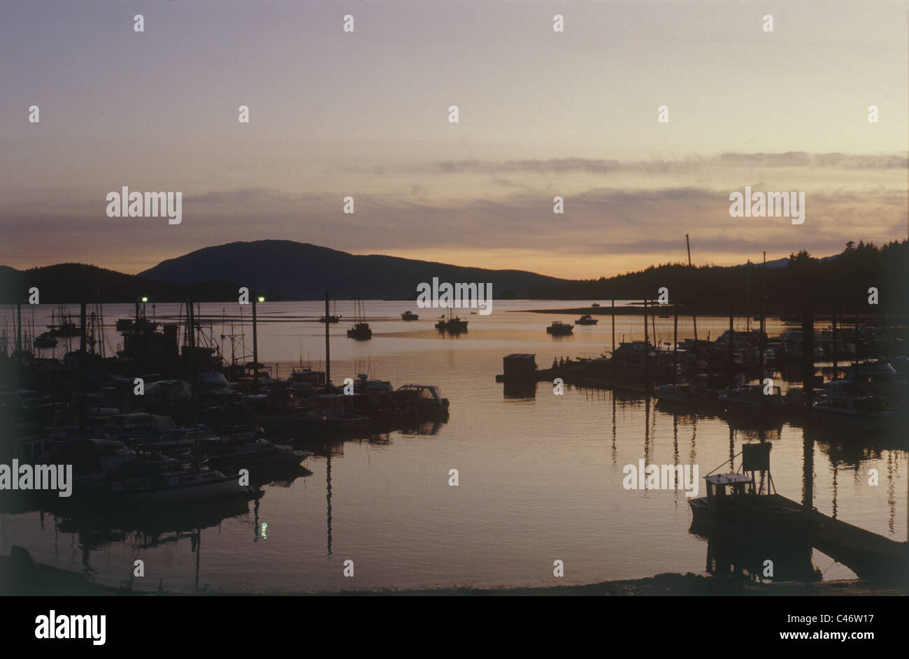 Photograph of a small harbor in Alska at sunset Stock Photo