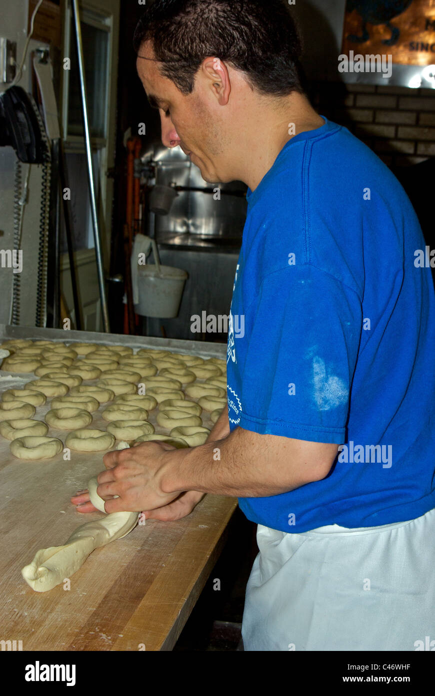 Baker hand rolling bagels at Saint-Viateur bagel bakery Plateau district Montreal Quebec Stock Photo