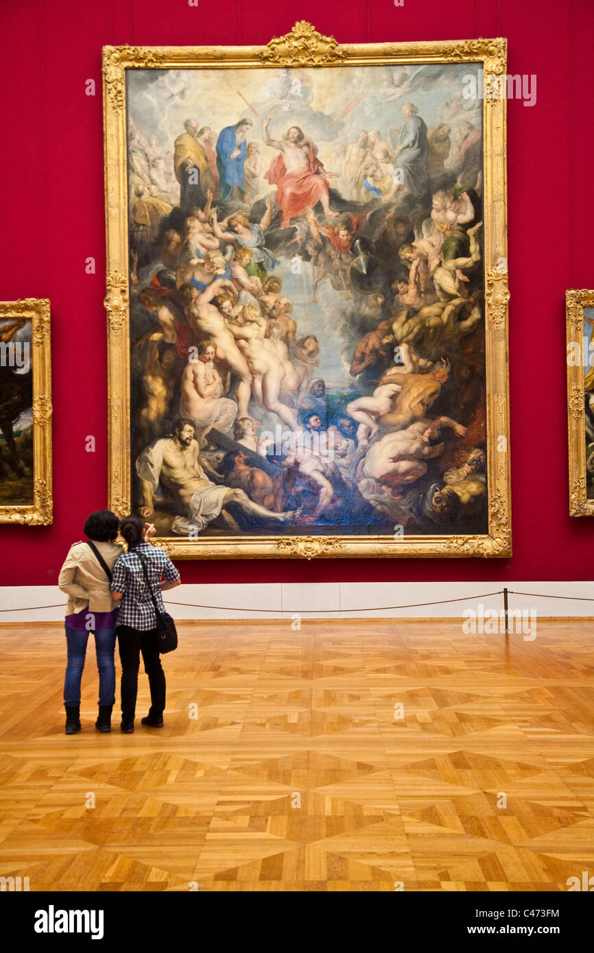 Two people looking at The Last Judgement by Peter Paul Rubens 1617 in the Alte Pinakothek, Munich, Germany Stock Photo