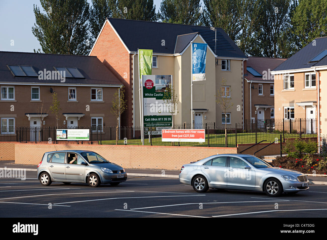 New Barratt Homes with solar heating panels on roofs alongside a busy