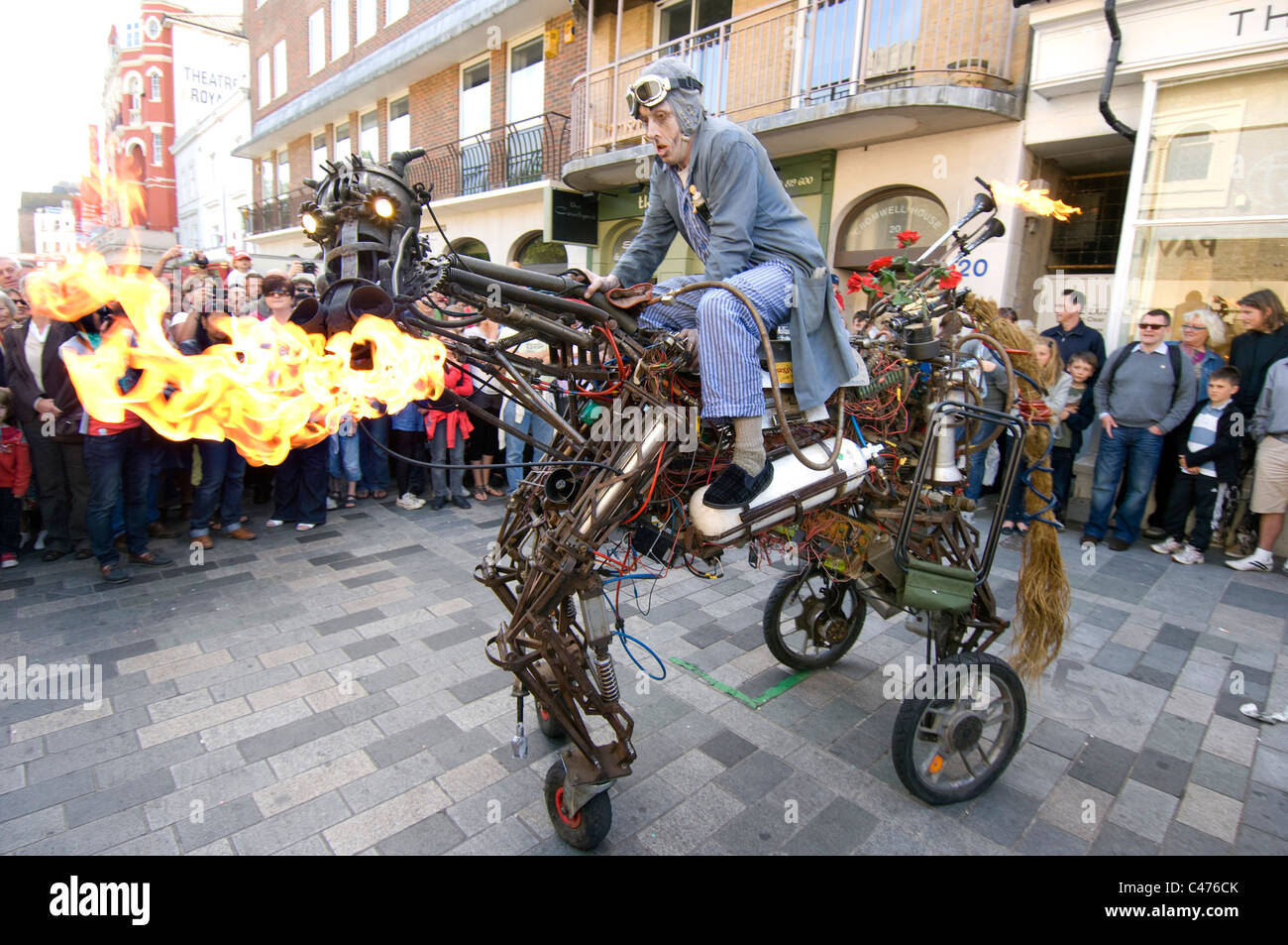 A street entertainer rides his fire breathing iron horse during the 2011 Brighton Festival Fringe Stock Photo