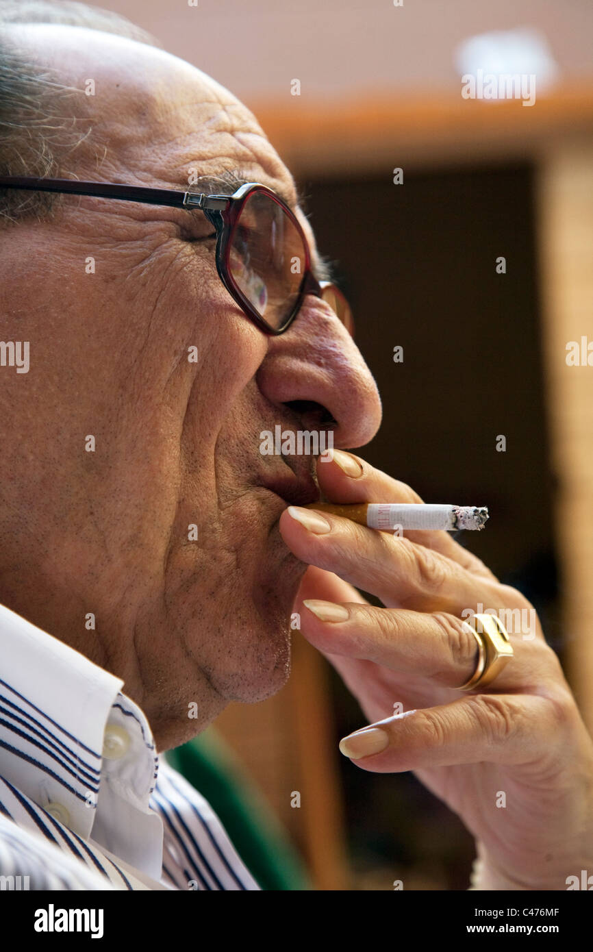 cigarette in spanish Old Spanish man smoking a cigarette Stock Photo