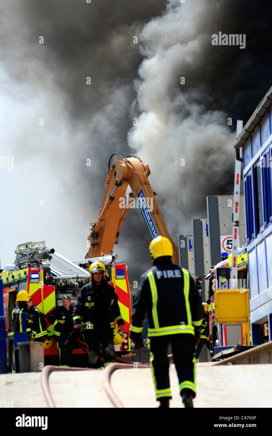 Firefighters tackle a blaze in a recycling plant in London Stock Photo ...