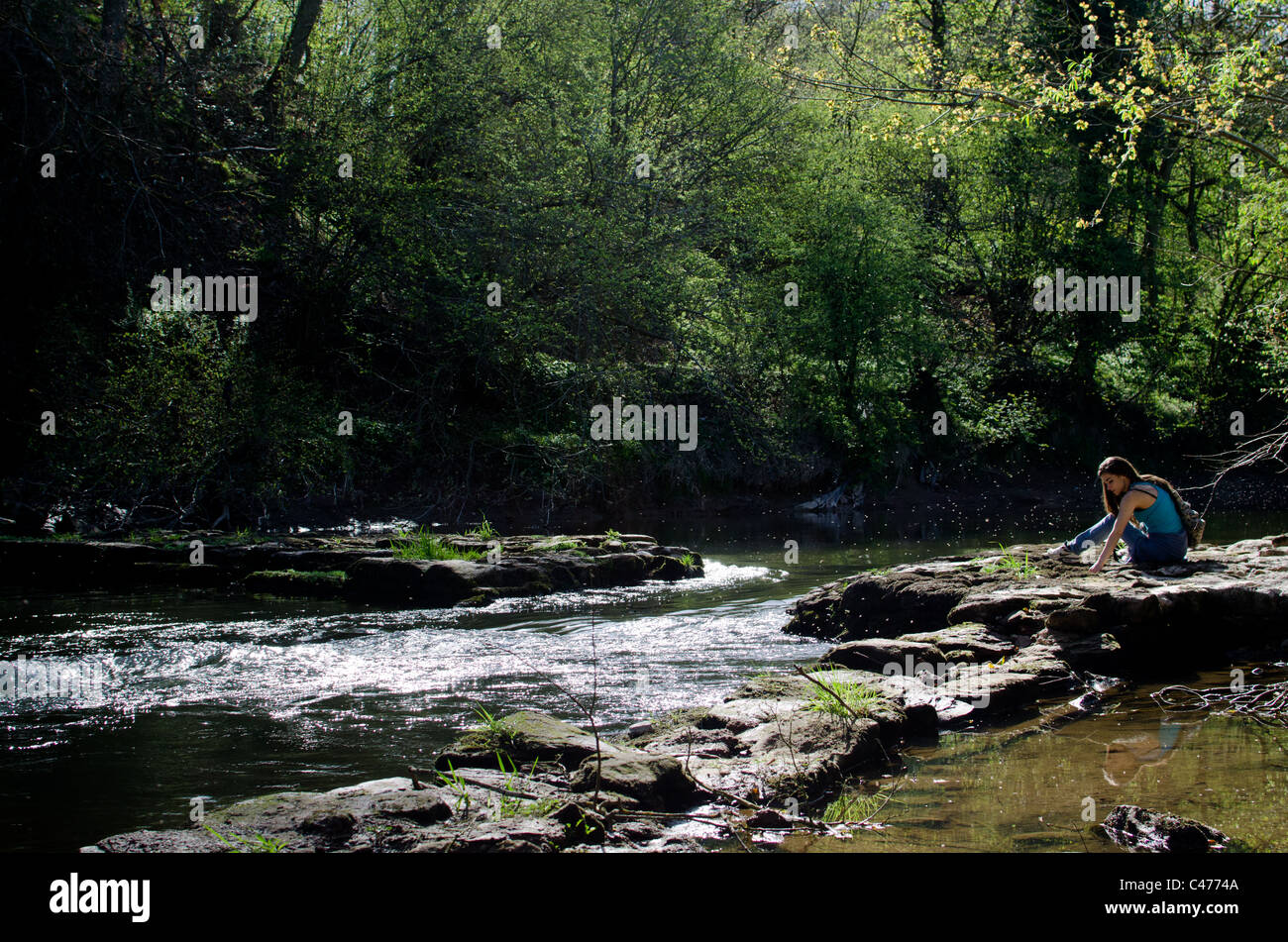 A pretty girl relaxing by the river Stock Photo - Alamy