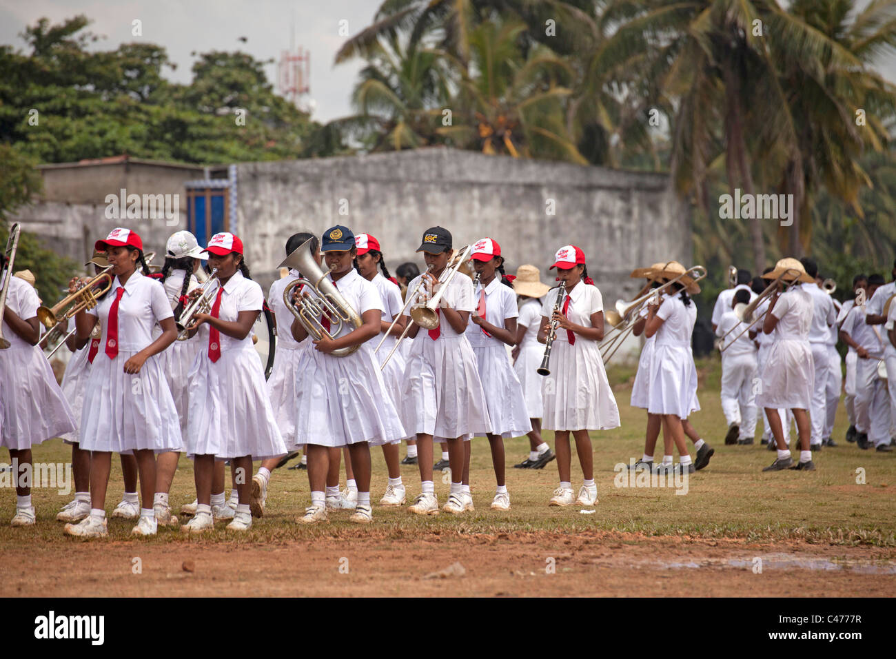 school girls in uniform, members of a marching band during a parade in