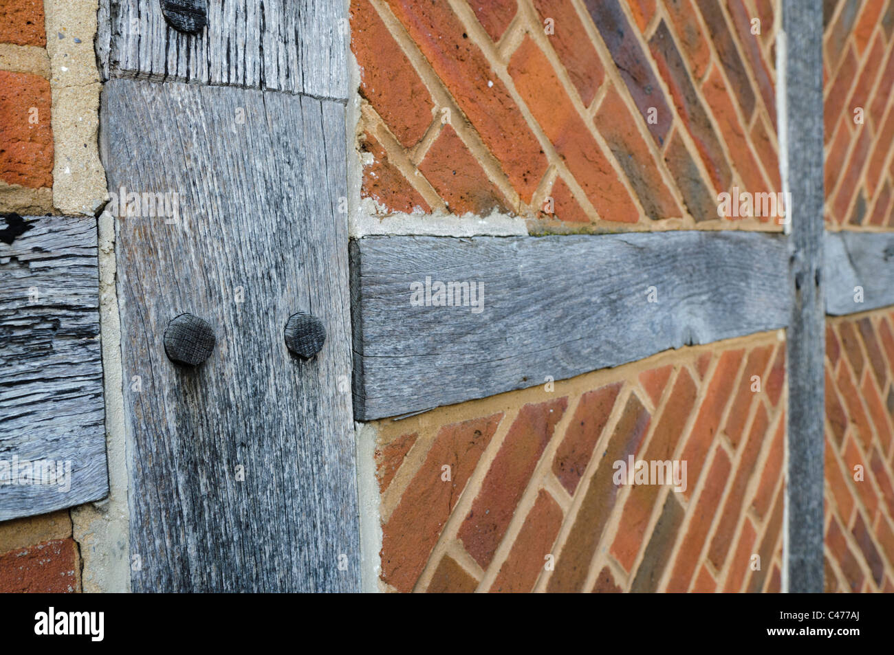 Traditional English wood timber framed brick construction, with wooden pins Stock Photo