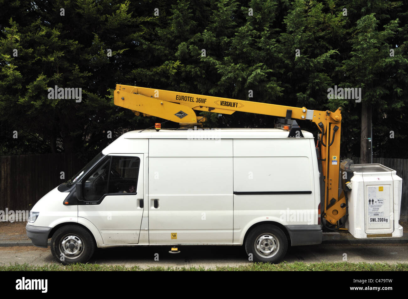 BT engineer replacing tree damaged telephone cable using a mobile hoist