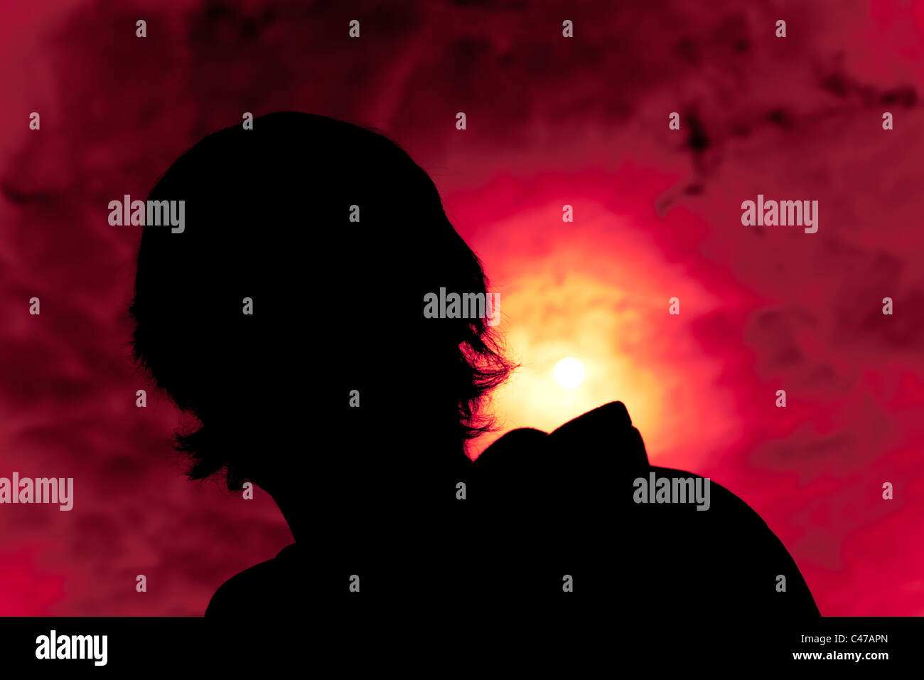 Silhouette of a young man and colourful sunset background Stock Photo ...