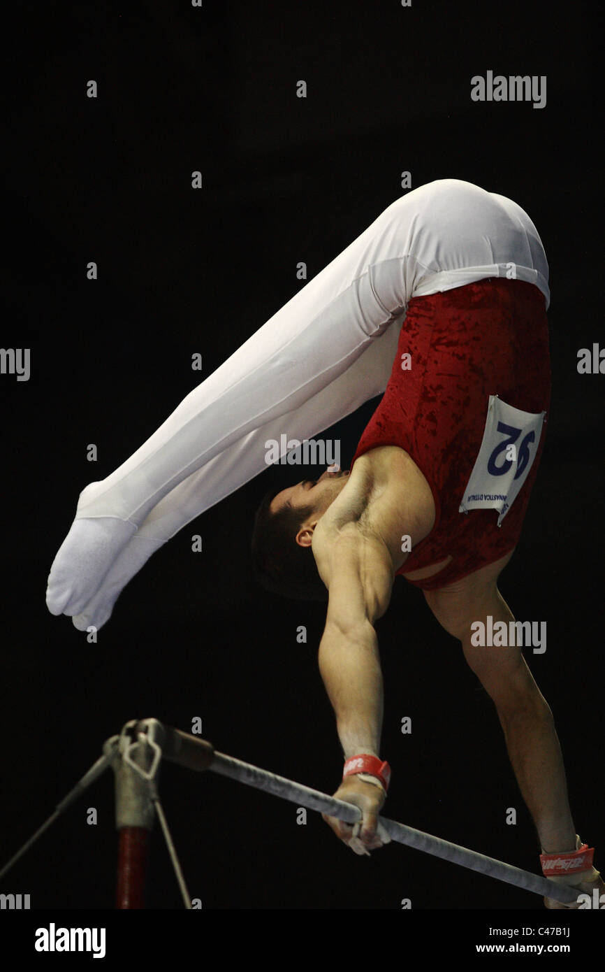 Gymnastics competition a gymnast is performing his high bar routine