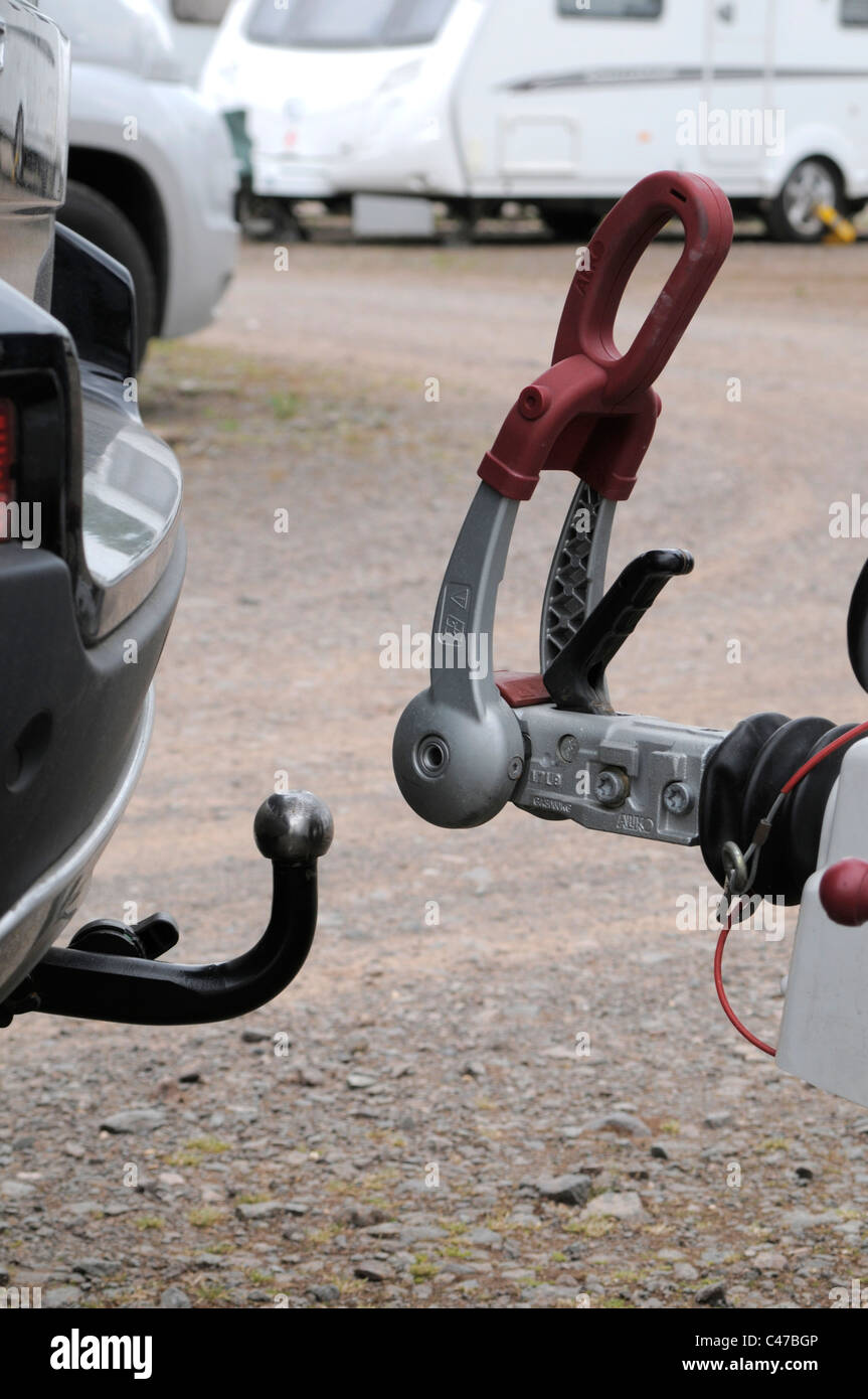 Tow Bar on Car with Caravan Hitch and Caravan in Background Stock Photo