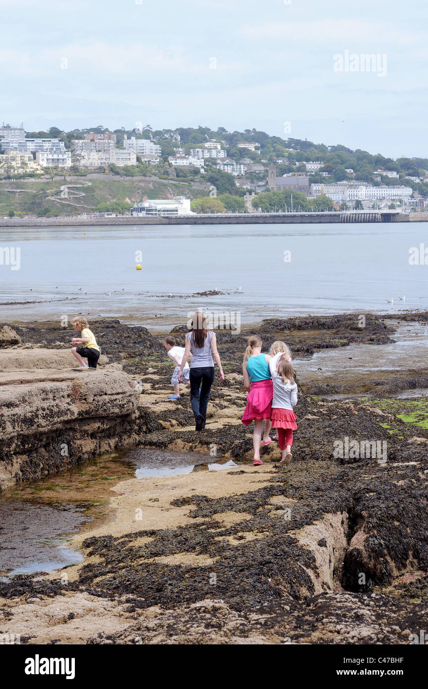 With beautiful beaches at our doorstep a single mum with large family at the seaside at low tide iTorquay,Devon,family holidays Stock Photo