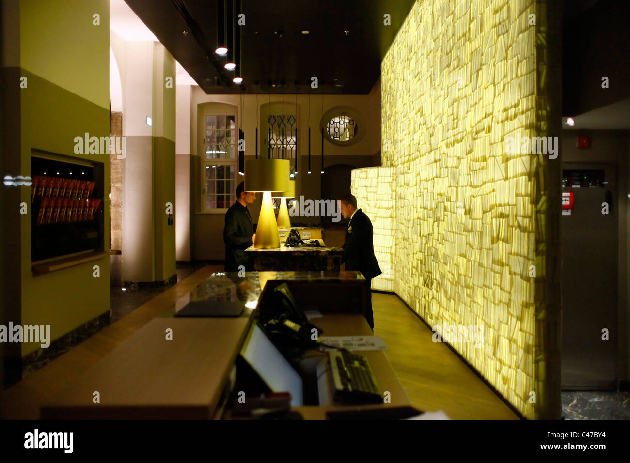 A front desk agent registers a guest at a hotel in Leipzig Saxony