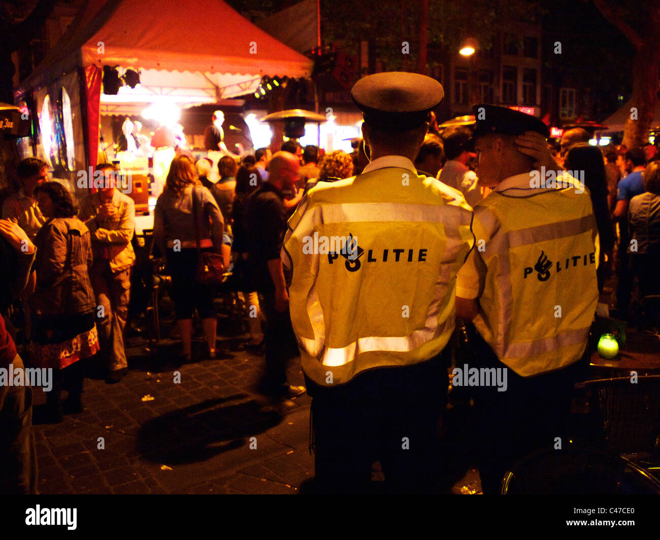 Police officers observing the crowd at night, at the Breda Jazz festival, the Netherlands Stock Photo