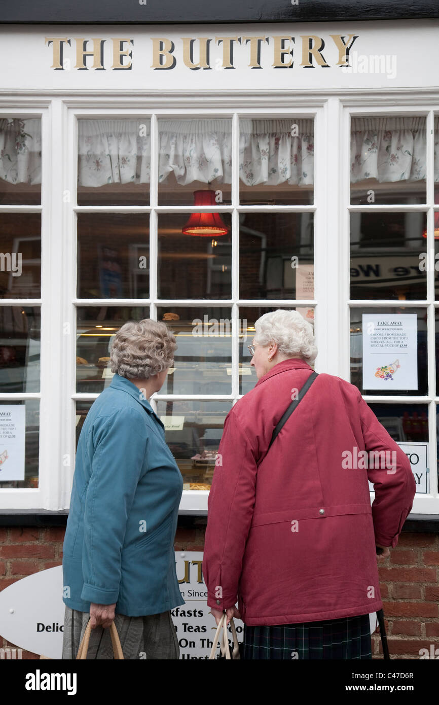 Two pensioners looking at the menu in Cafe window, Lymington, Hampshire, UK. Photo:Jeff Gilbert Stock Photo