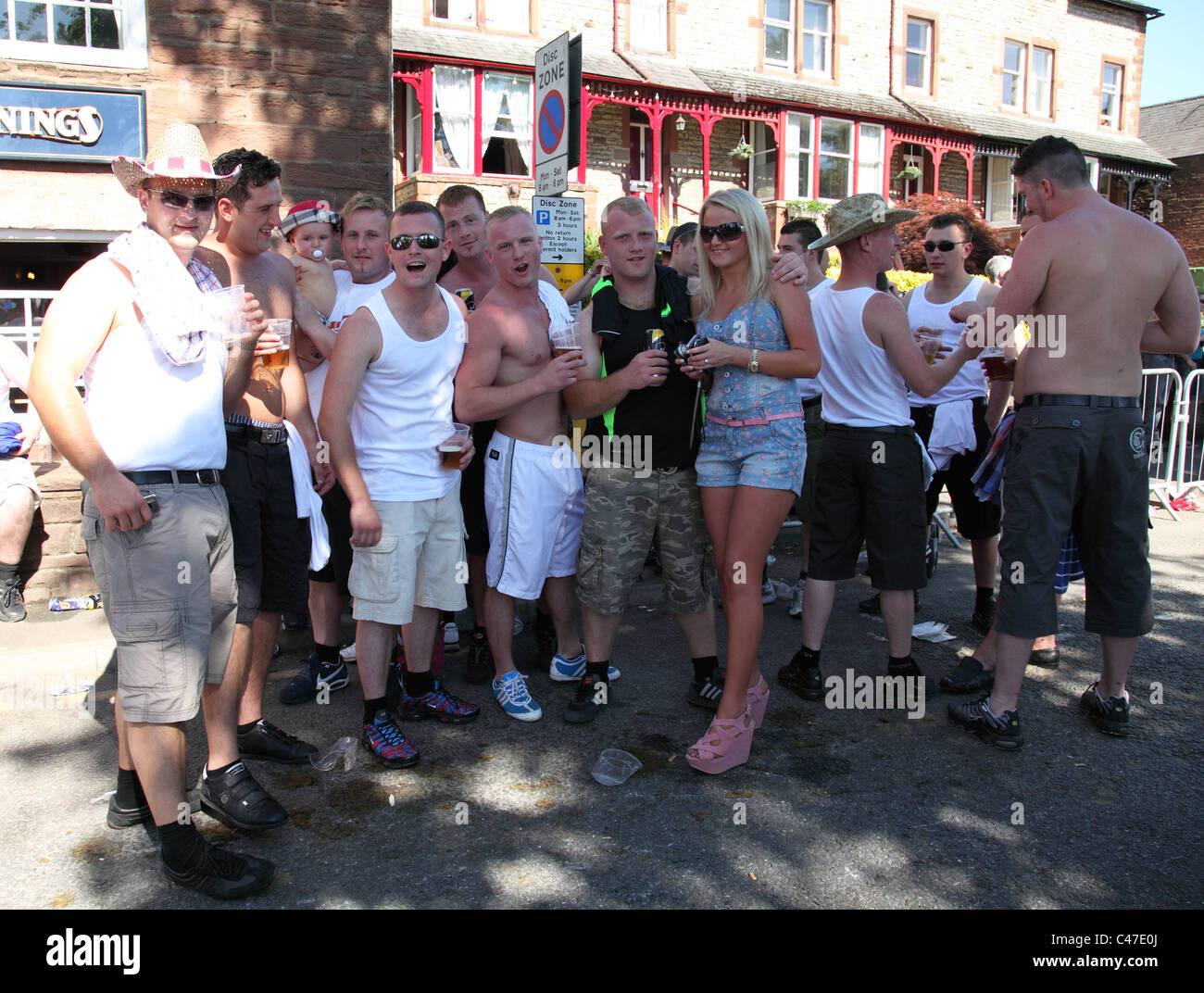 Young people drinking alcohol outside a public house in Appleby-In-Westmorland, Cumbria, England, U.K. Stock Photo