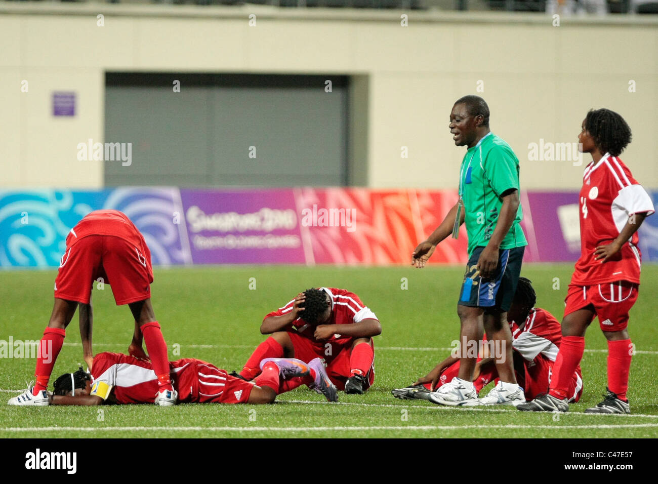 The shocked Equatorial Guinea players react to their defeat during the penalty kick-off of the Women's Gold Medal Match between Stock Photo