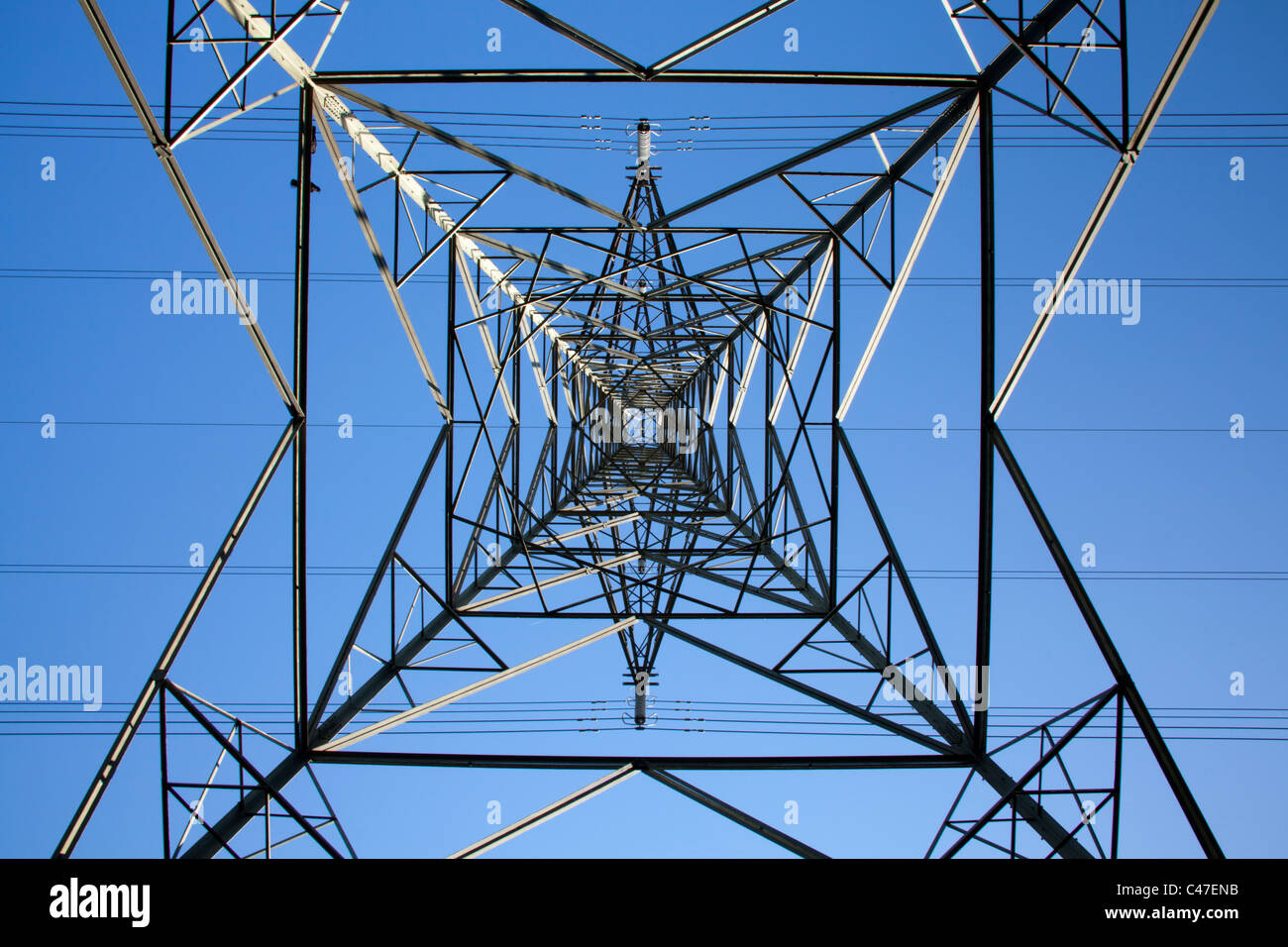 Upward view of electricity pilon with blue sky Stock Photo