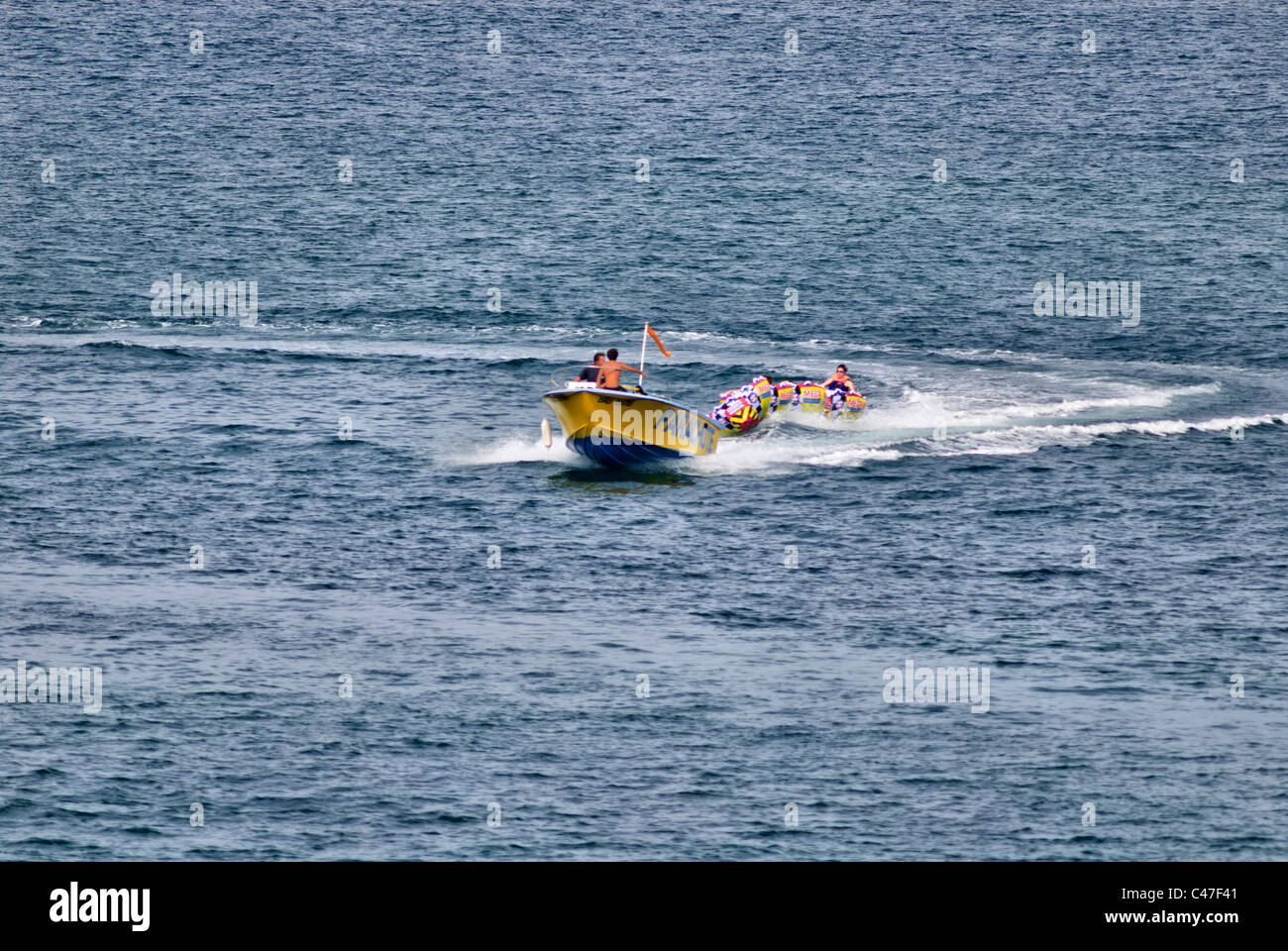 Boat pulling mega bowl Water tubing Stock Photo Alamy
