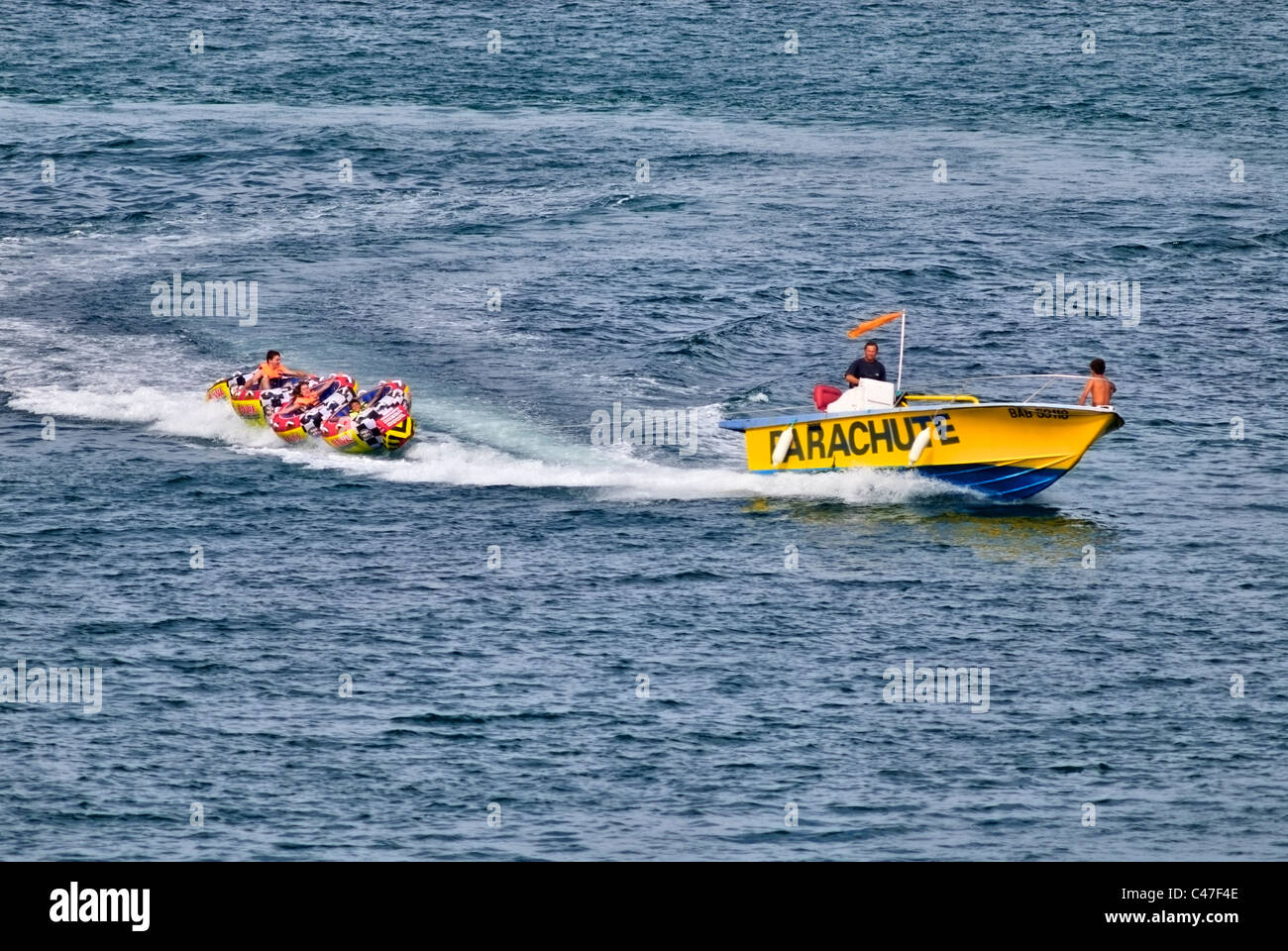 Boat pulling mega bowl Water tubing Stock Photo Alamy