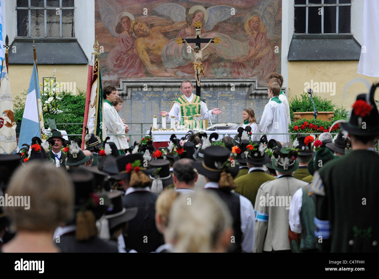 outdoor catholic mass on city place in Neubeuern, Bavaria, Germany, with people in traditional Bavarian clothes Stock Photo
