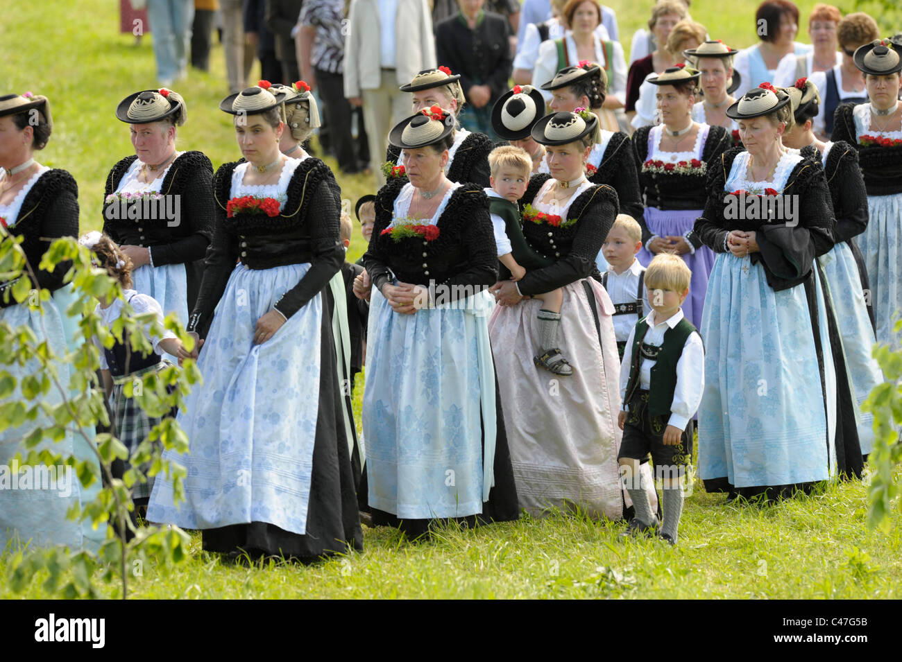 catholic traditional procession in costumes and typical bavarian clothes in Wackersberg, Bavaria, Germany Stock Photo