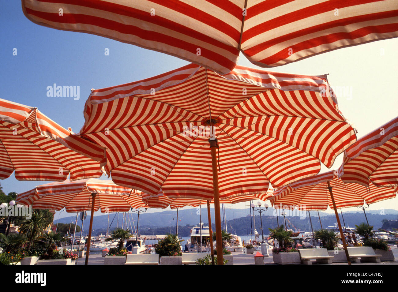 Red And White Striped Sidewalk Umbrellas Frame The Marina At Porto