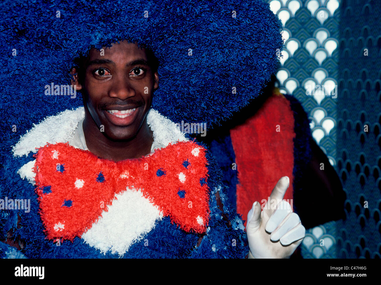 This dancer in his colorful costume is among the many revelers who join in the entertaining Junkanoo street parades in the islands of the Bahamas. Stock Photo