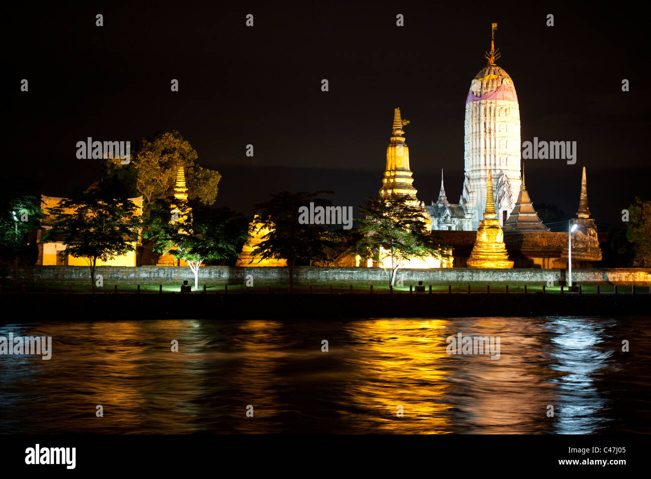 Wat Phutthai Sawan reflected at night, the prangs are characteristic of the early Ayutthaya period Stock Photo