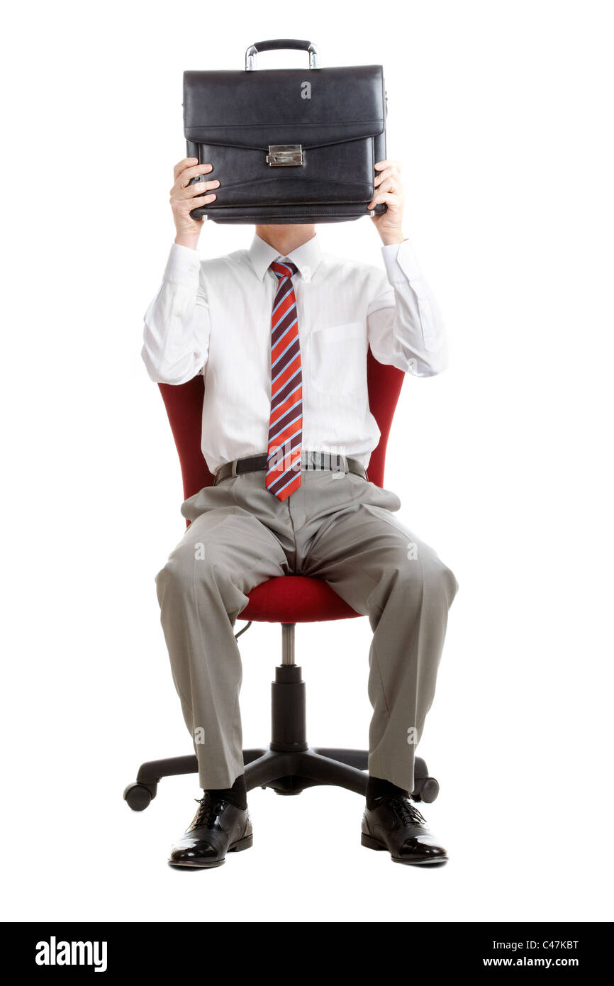 Portrait of shy businessman hiding his face behind briefcase Stock Photo