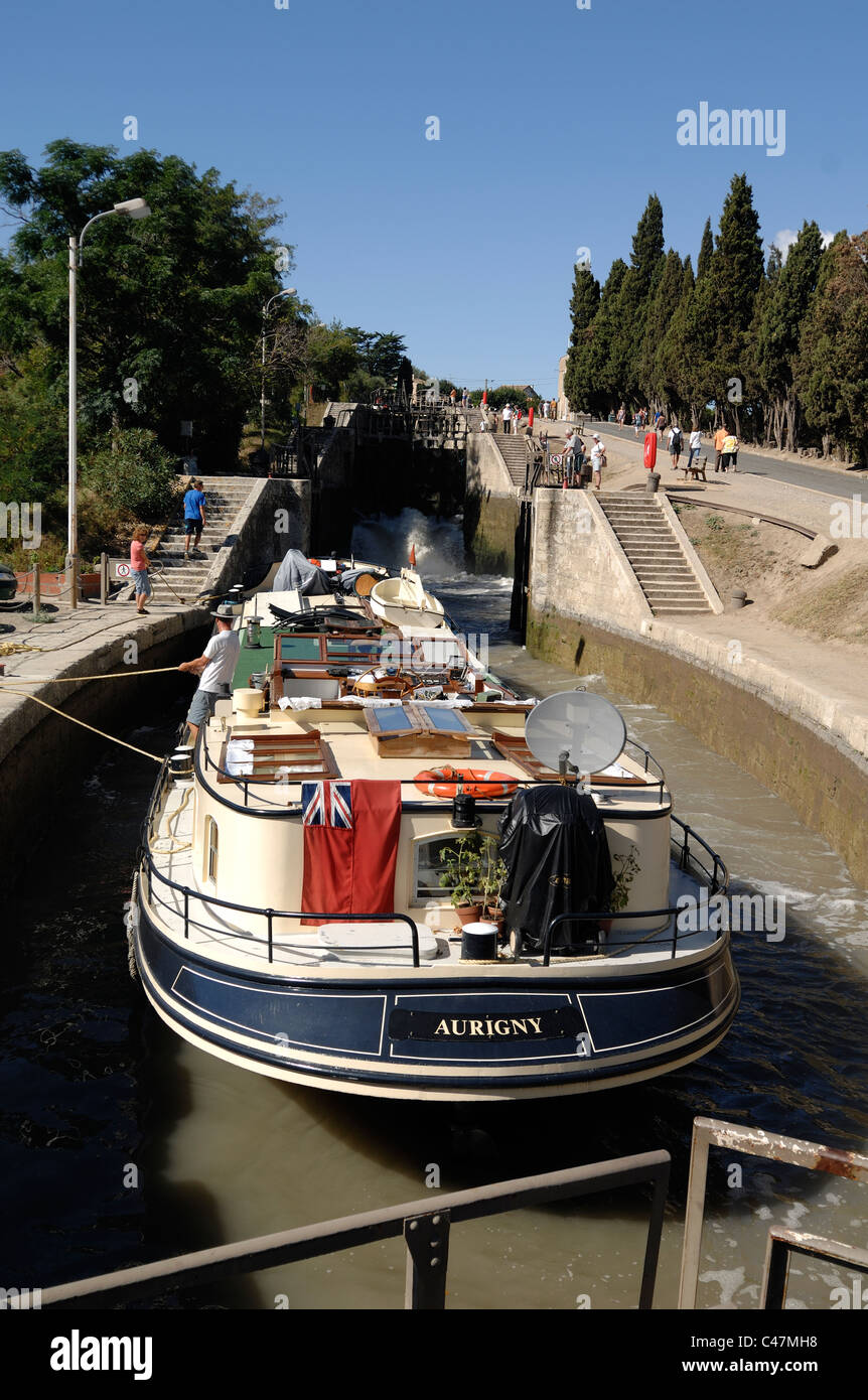 Canal Boat or Longboat in Lock (Neuf Ecluses) on the Canal du Midi at Béziers Hérault France Stock Photo