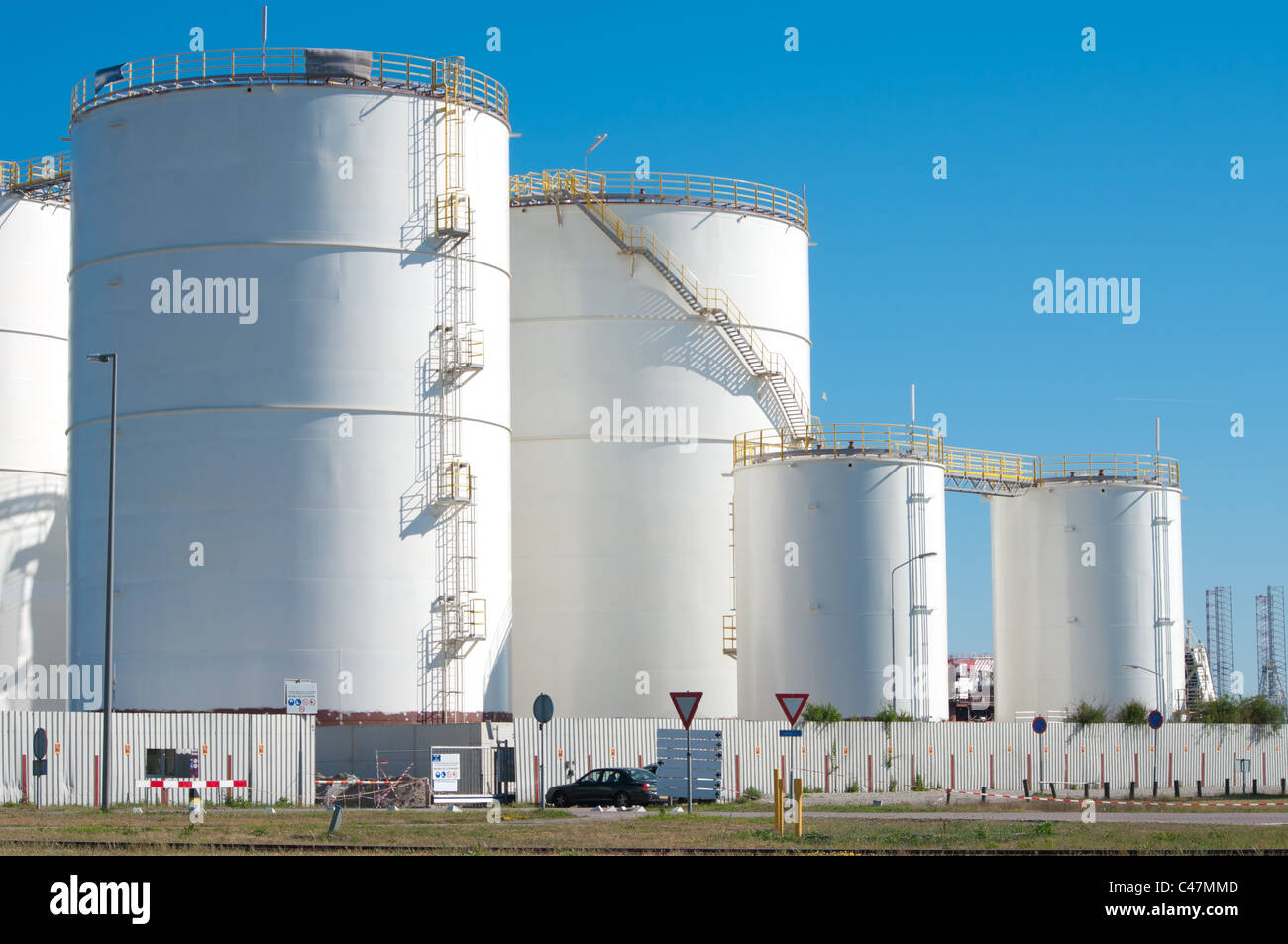 large white tanks for petrol and oil in the Rotterdam harbor Stock Photo