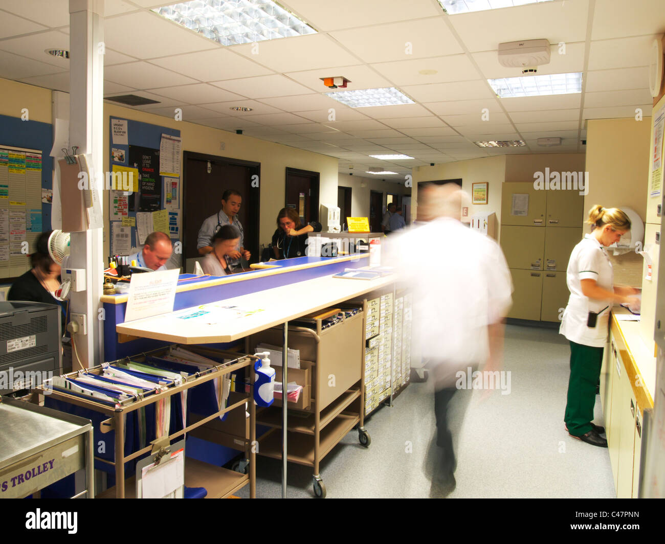 Busy UK NHS Hospital Ward, blurred movement showing action form nursing staff Stock Photo