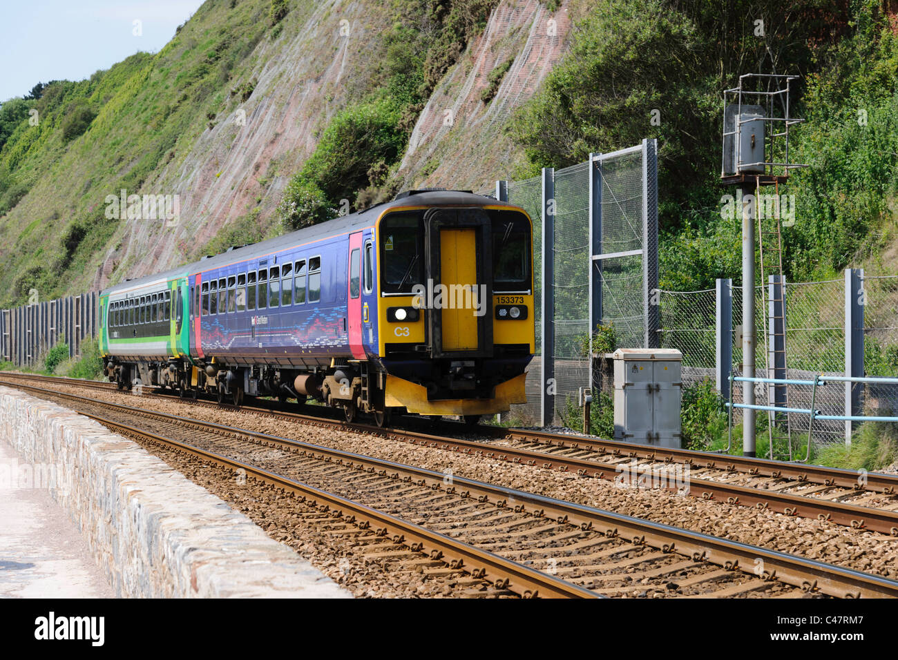 A First Great Western Class 153 (153373) heads a 2 car DMU towards Dawlish along the sea wall at Holcombe. Stock Photo