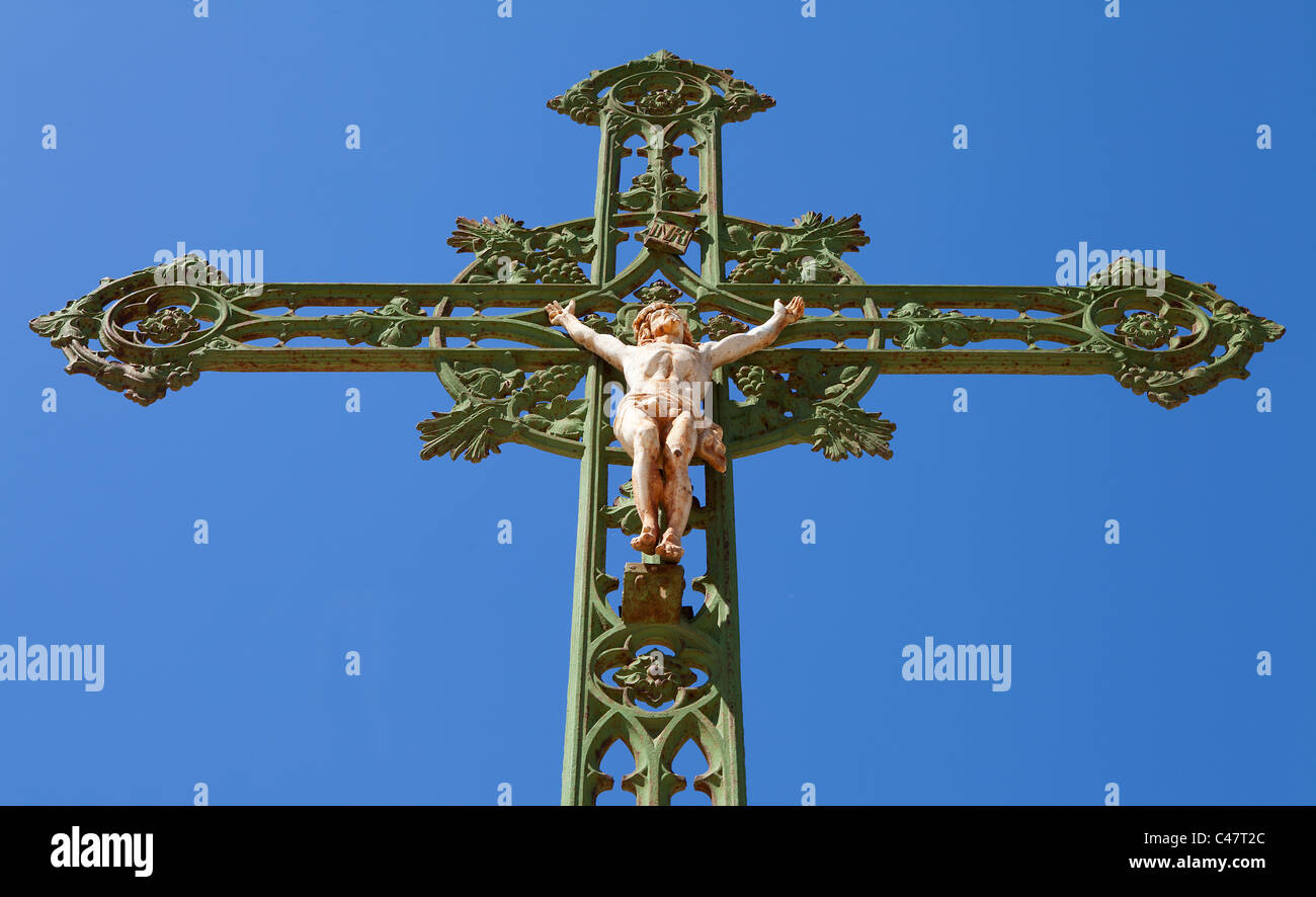 Statue of jesus on cross against blue sky Stock Photo - Alamy