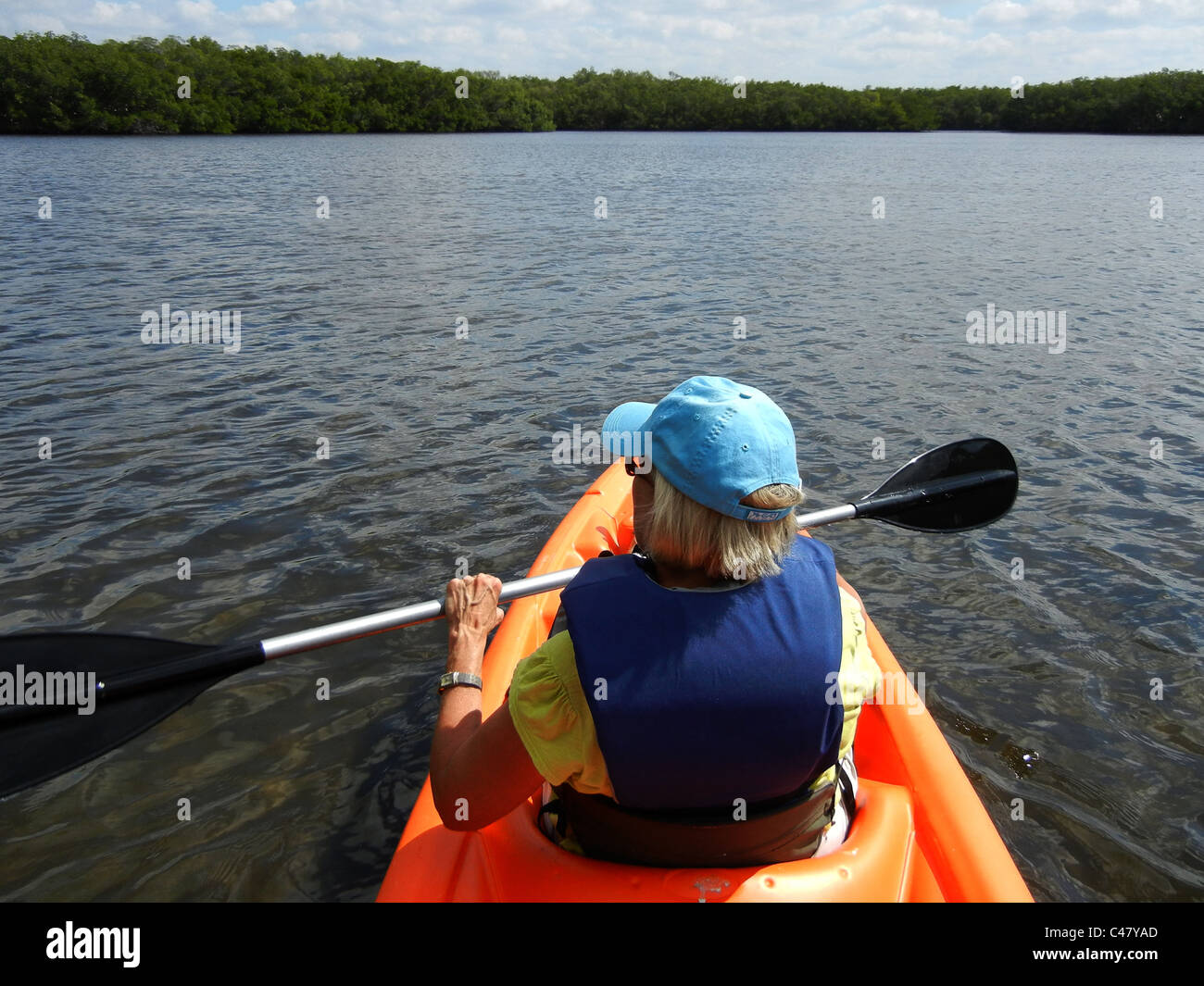 Female paddling kyak in back waters of Tampa Bay Florida at Ruskin Stock Photo