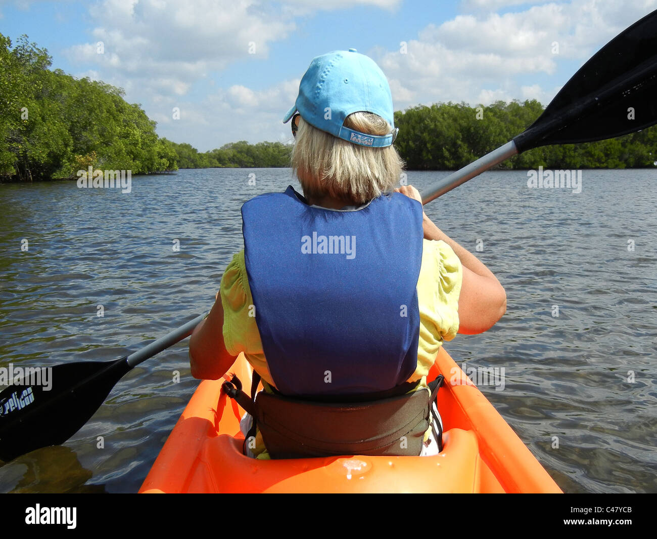 Female paddling kayak in back waters of Tampa Bay Florida at Ruskin Stock Photo