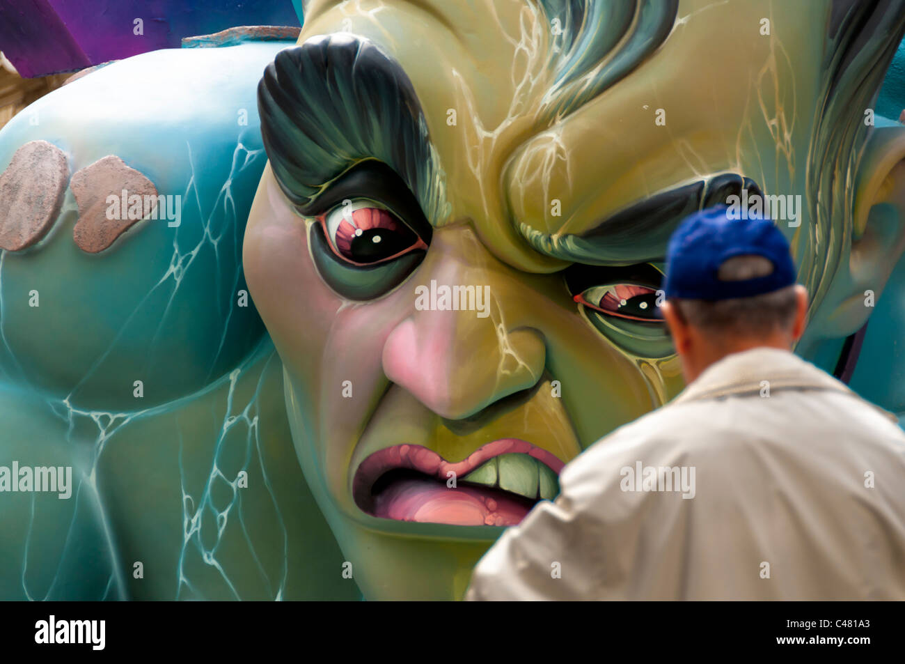 A man looks at on of the figures during Fallas festival, in Valencia. Stock Photo