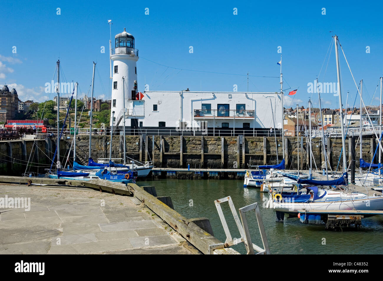 Scarborough lighthouse and harbour in spring North Yorkshire England UK United Kingdom GB Great Britain Stock Photo