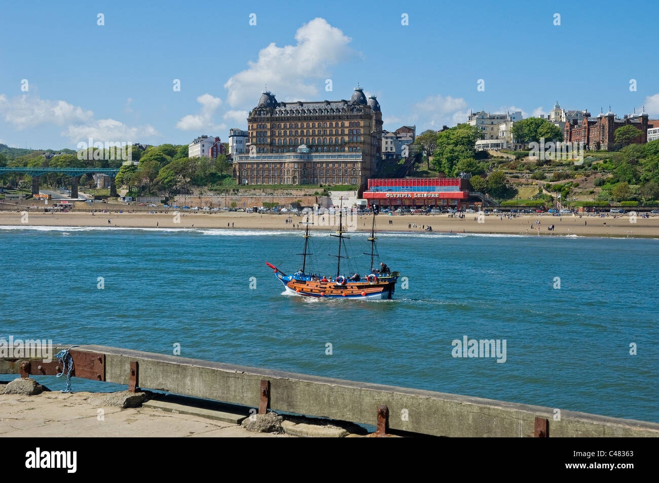 Pleasure boat with Grand Hotel in background South Bay Scarborough North Yorkshire England UK United Kingdom GB Great Britain Stock Photo