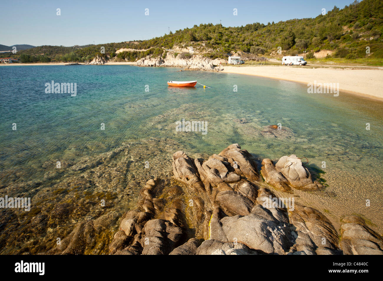 small bay with boat and Camper Mobile near Toroni, Sithonia, Chalkidiki, Greece Stock Photo