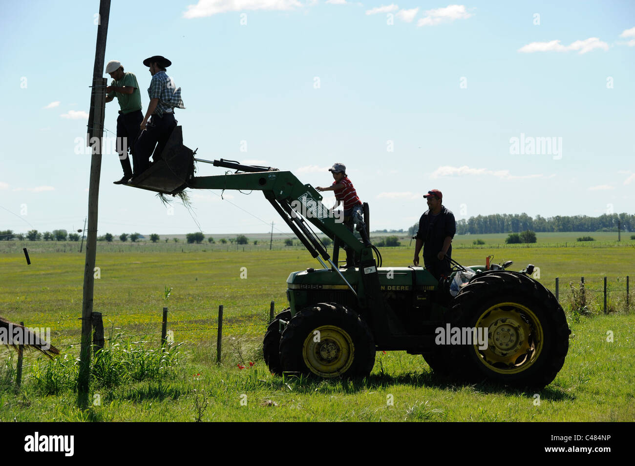 URUGUAY agriculture and livestock , Gauchos with tractor work on farm