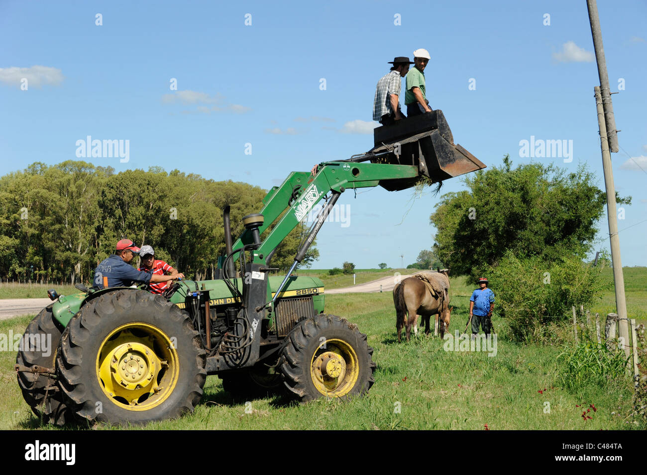 URUGUAY agriculture and livestock , Gauchos with horse and tractor work